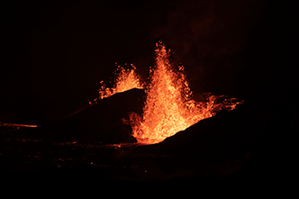 Night-time view of the eruption (lava fountains) from two vents and edge of lava pool in Halemaumau Crater as seen from the Crater Rim Trail (after dark). (Zoom view)